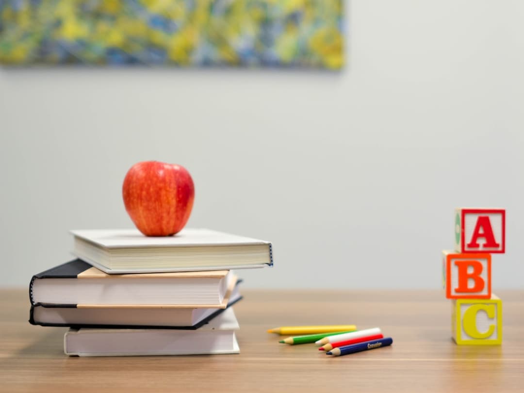 Books and alphabet blocks stacked on a desk